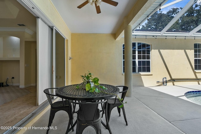 view of patio / terrace with ceiling fan and a lanai