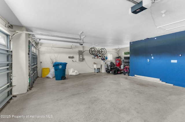 garage with electric panel and a garage door opener