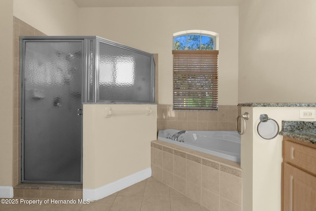 full bath with a stall shower, a garden tub, vanity, and tile patterned floors