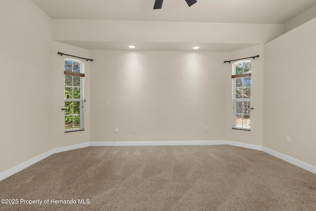 carpeted spare room with recessed lighting, a ceiling fan, and baseboards