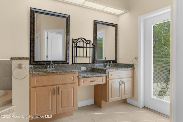 full bath featuring a wealth of natural light, tile patterned flooring, a sink, and double vanity