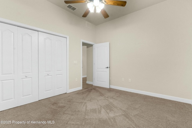 unfurnished bedroom featuring carpet floors, a closet, visible vents, and baseboards