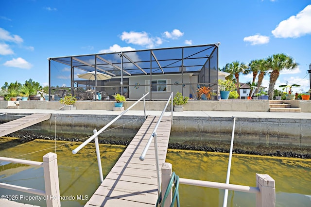 view of dock featuring glass enclosure and a water view