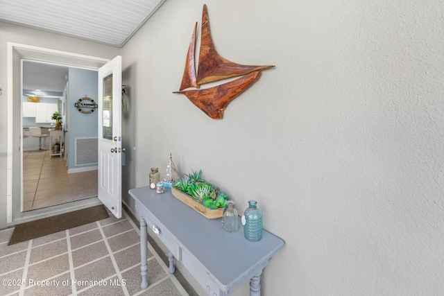 interior space featuring tile patterned flooring and visible vents