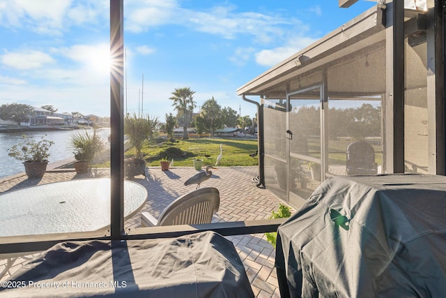 view of patio / terrace featuring a water view, area for grilling, and outdoor dining space