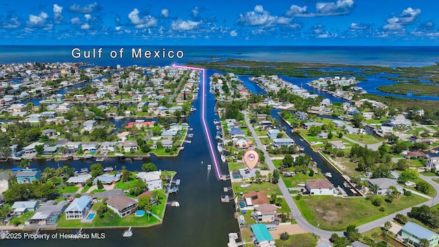 drone / aerial view with a water view and a residential view