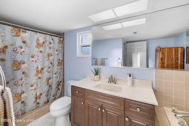 bathroom with curtained shower, visible vents, vanity, and toilet