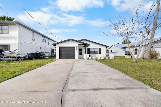 modern inspired farmhouse with driveway, an attached garage, fence, and a front yard