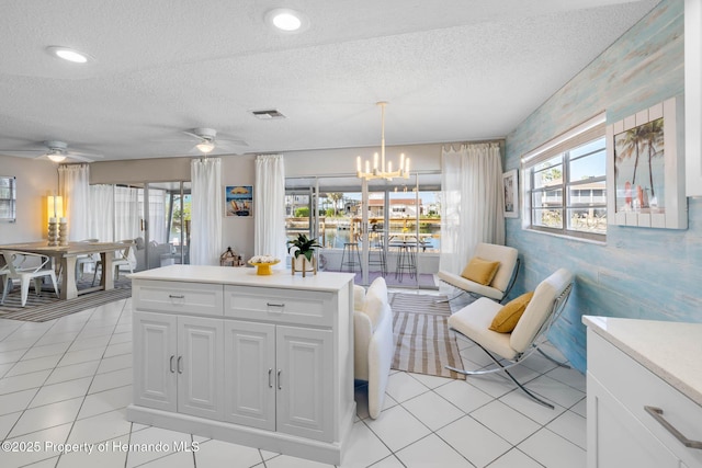 kitchen featuring light countertops, visible vents, plenty of natural light, and a textured ceiling