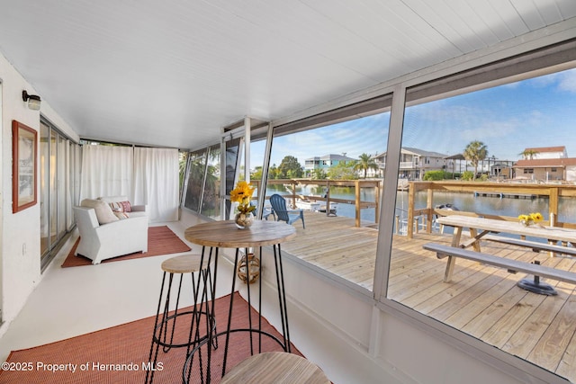 sunroom with a water view