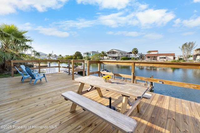 view of dock with a water view and a residential view