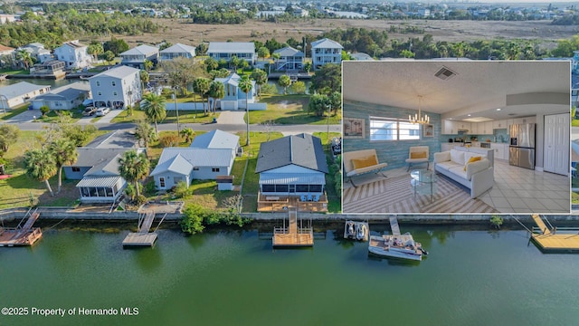 drone / aerial view featuring a water view and a residential view