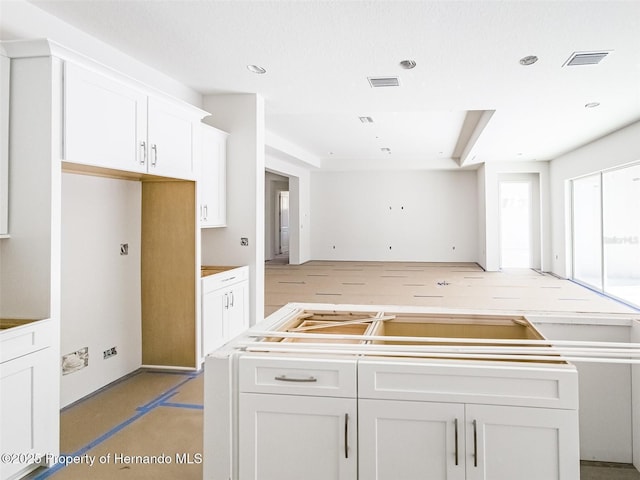 kitchen with recessed lighting, visible vents, and white cabinets