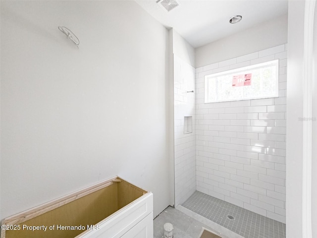 bathroom featuring visible vents and tiled shower