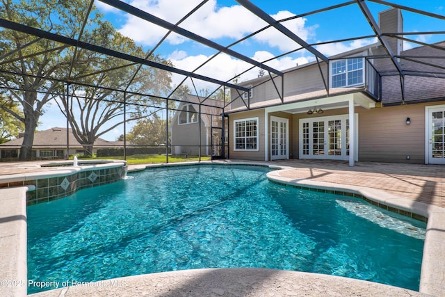 pool featuring a lanai, a patio area, and french doors