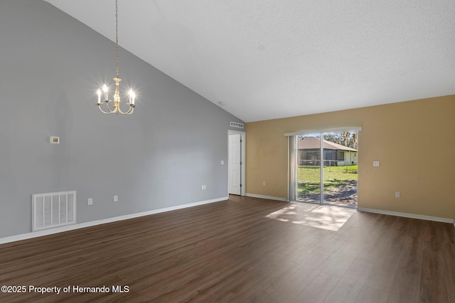 unfurnished room featuring dark wood-type flooring, visible vents, a notable chandelier, and baseboards