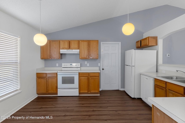 kitchen with white appliances, under cabinet range hood, vaulted ceiling, and a sink