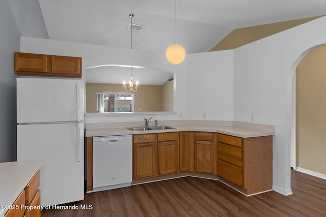 kitchen with lofted ceiling, white appliances, light countertops, and a sink