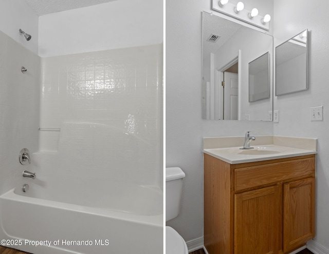 bathroom featuring visible vents, vanity, toilet, and shower / bathtub combination