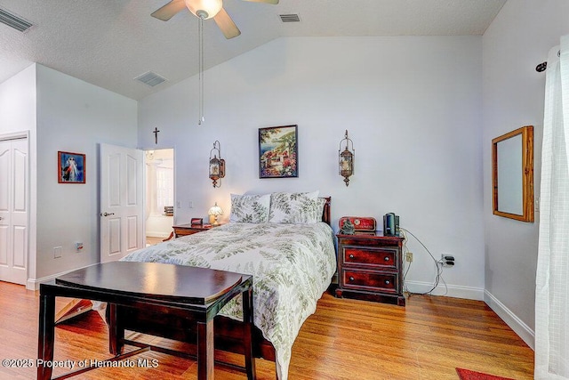 bedroom featuring baseboards, visible vents, and wood finished floors