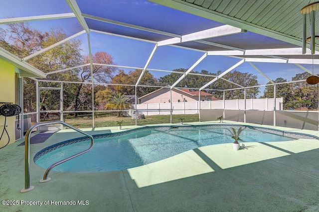 view of swimming pool with a lanai, fence, a fenced in pool, and a patio