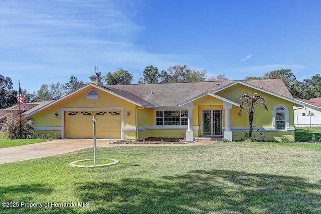 single story home featuring concrete driveway, an attached garage, french doors, a front lawn, and stucco siding