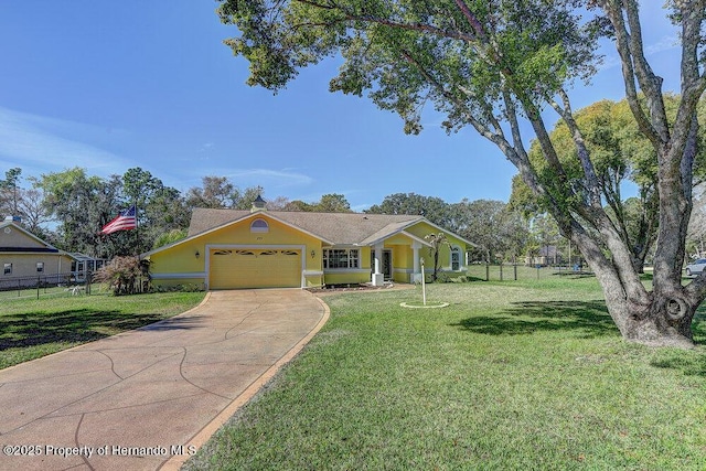 view of front facade with concrete driveway, fence, a front lawn, and an attached garage