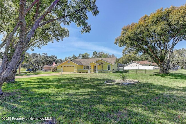 ranch-style house with a front lawn, an attached garage, and fence