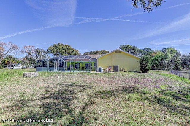 view of yard with a lanai and fence