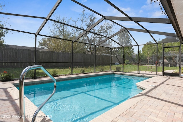 view of swimming pool featuring a fenced in pool, a lanai, a patio area, and fence