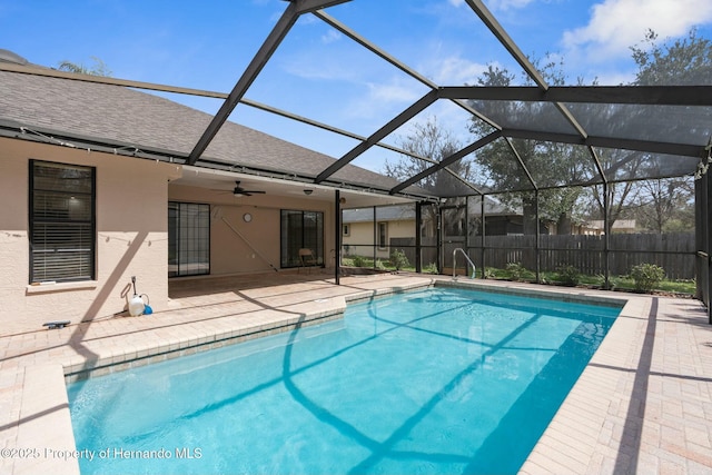 view of pool featuring a fenced in pool, a ceiling fan, glass enclosure, fence, and a patio area