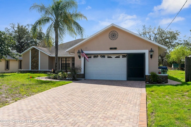ranch-style home featuring a garage, decorative driveway, a front lawn, and stucco siding
