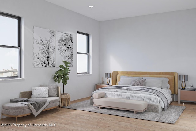 bedroom with recessed lighting and wood finished floors