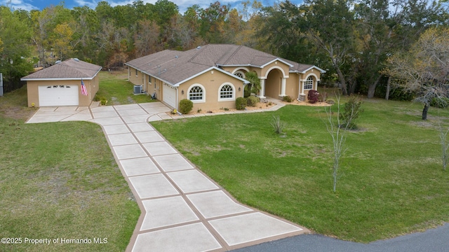 mediterranean / spanish-style home featuring concrete driveway, roof with shingles, a front yard, and stucco siding