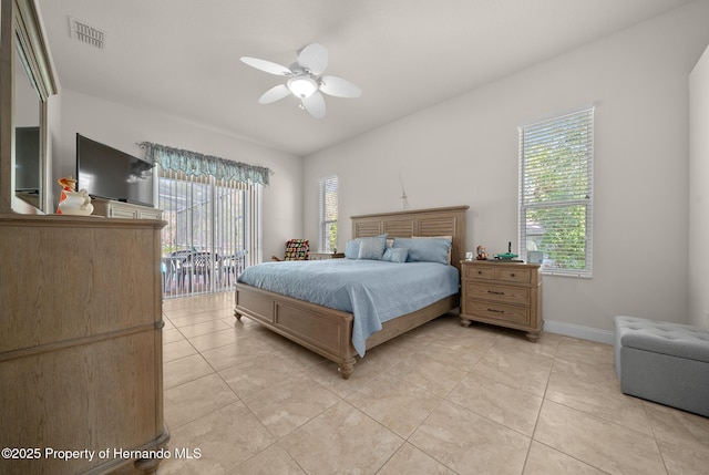 bedroom with light tile patterned floors, multiple windows, and visible vents