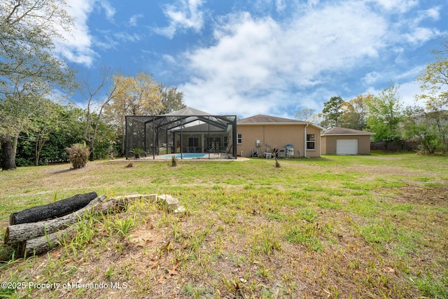 rear view of property featuring a garage, an outdoor pool, a lawn, glass enclosure, and stucco siding