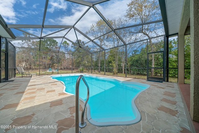 outdoor pool featuring a lanai and a patio area