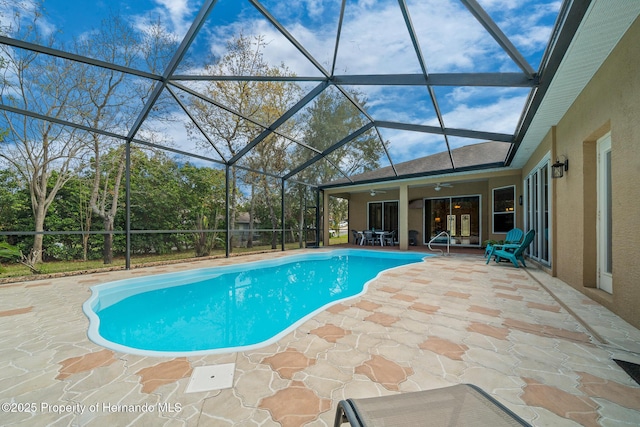 pool with ceiling fan, a patio area, and a lanai