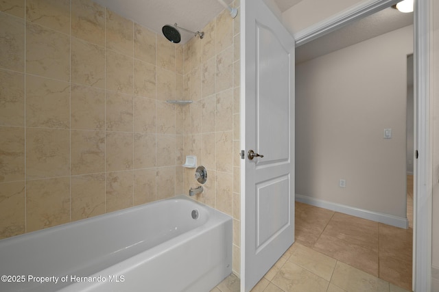 full bathroom with baseboards, bathtub / shower combination, and tile patterned floors