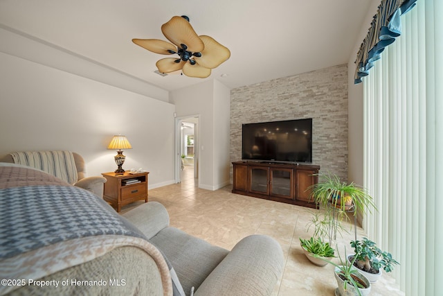 tiled bedroom with ceiling fan and baseboards