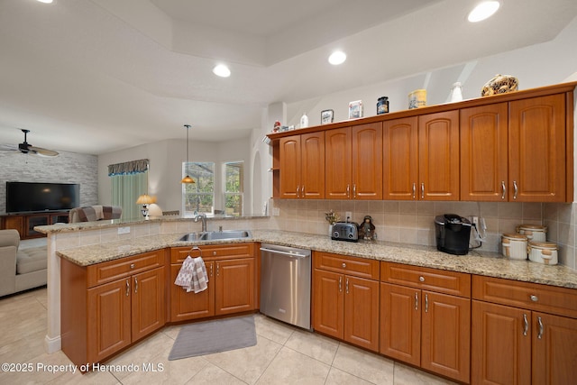 kitchen featuring a peninsula, a sink, open floor plan, dishwasher, and tasteful backsplash