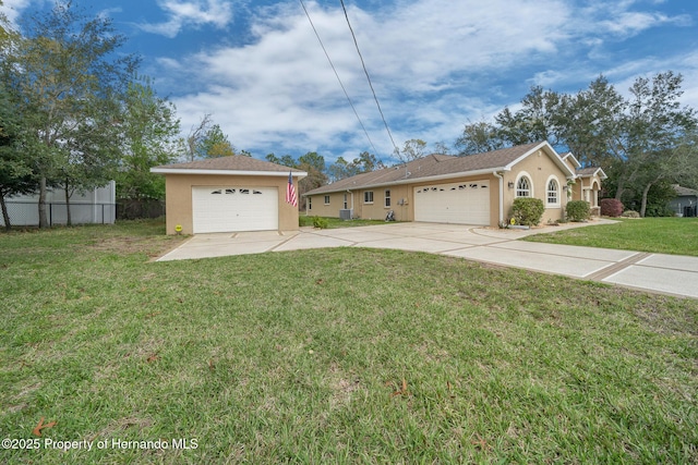 exterior space featuring a garage, fence, and stucco siding