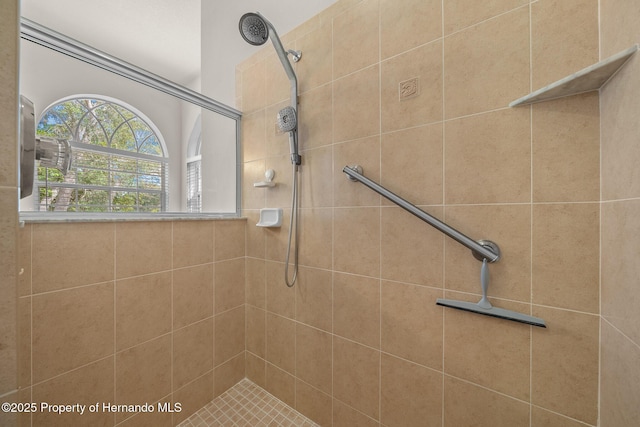 bathroom with tiled shower