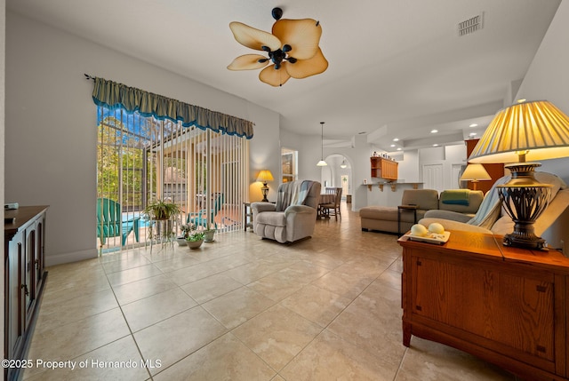 living room featuring ceiling fan, light tile patterned floors, and visible vents