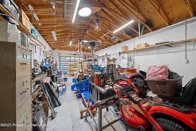 garage with concrete block wall and a workshop area