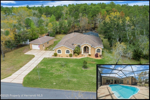 birds eye view of property featuring a view of trees