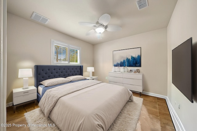 bedroom featuring a ceiling fan, visible vents, and baseboards