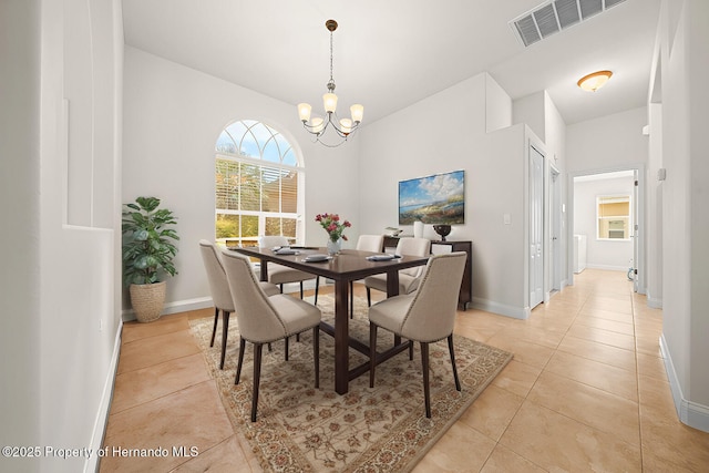 dining area featuring light tile patterned floors, baseboards, visible vents, and an inviting chandelier