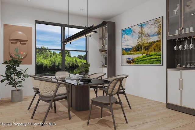 dining space with light wood-style flooring