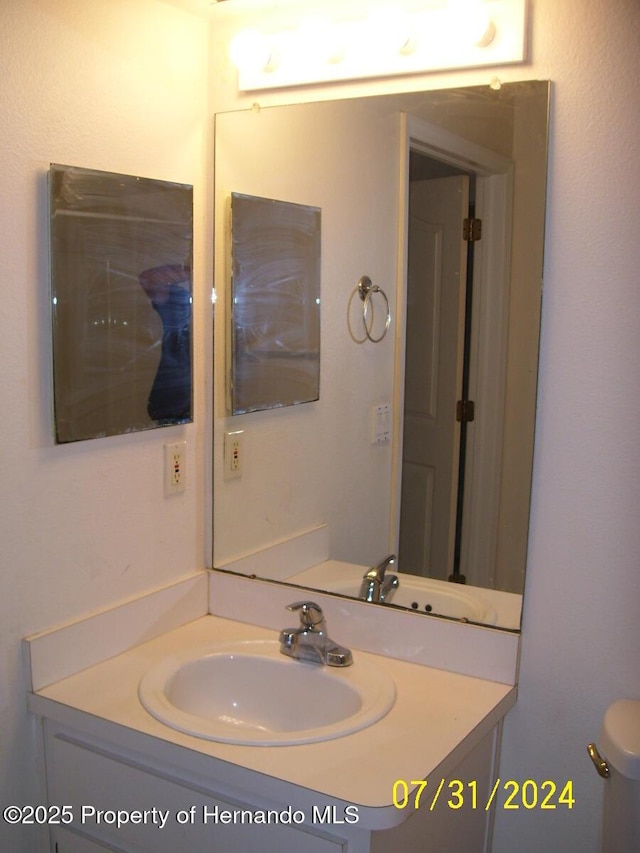 bathroom with toilet and vanity